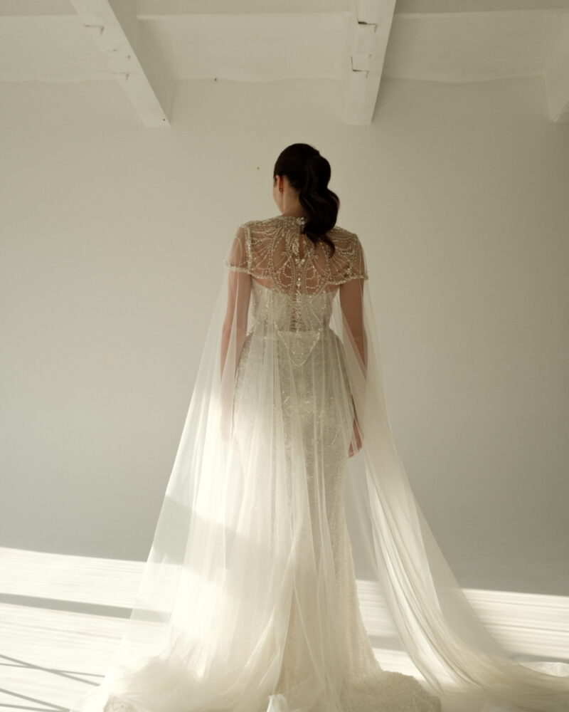 Crystal wedding dress with cape overlay, strapless design, elegant silhouette, Gilded Grace Photo 04